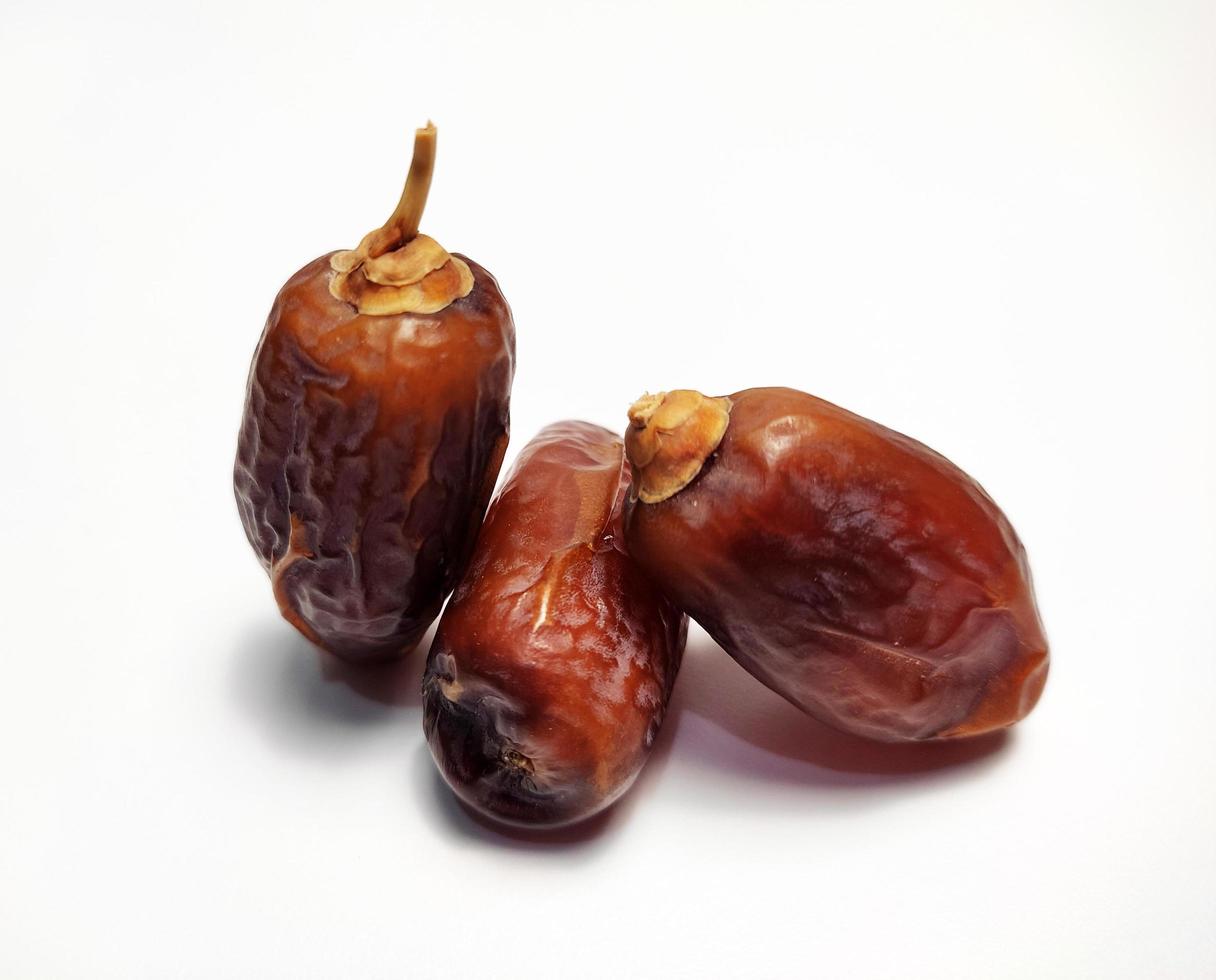 Close up of dried dates fruit isolated on white background photo
