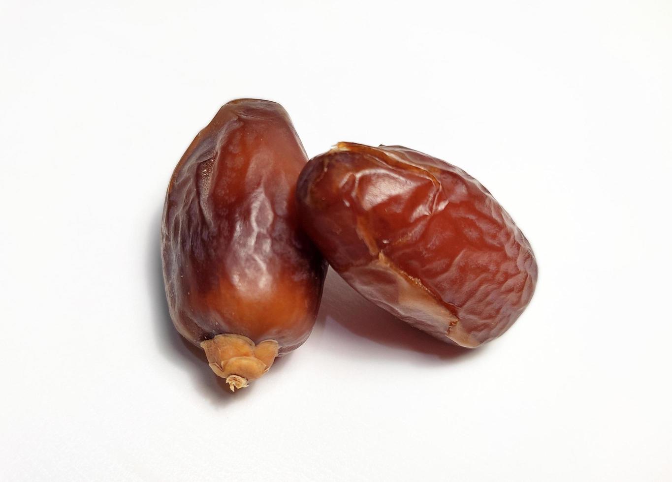 Close up of dried dates fruit isolated on white background photo