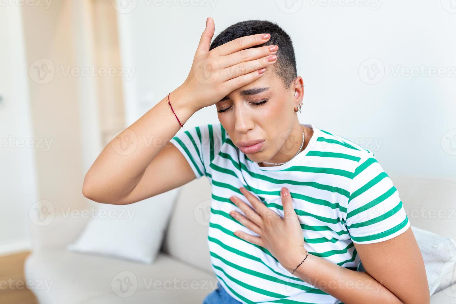 Breathing, respiratory problem, asthma attack, pressure, chest pain, sun stroke, dizziness concept. portrait of woman received heatstroke in hot summer weather, touching her forehead photo