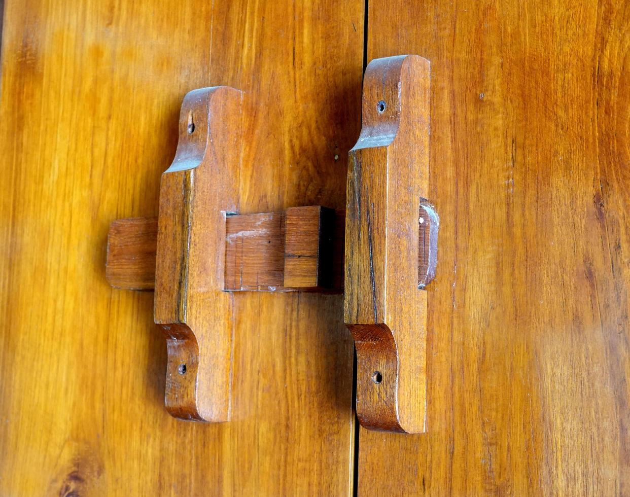 handmade wooden lock or ancient door latch.  Thailand traditional wood door photo