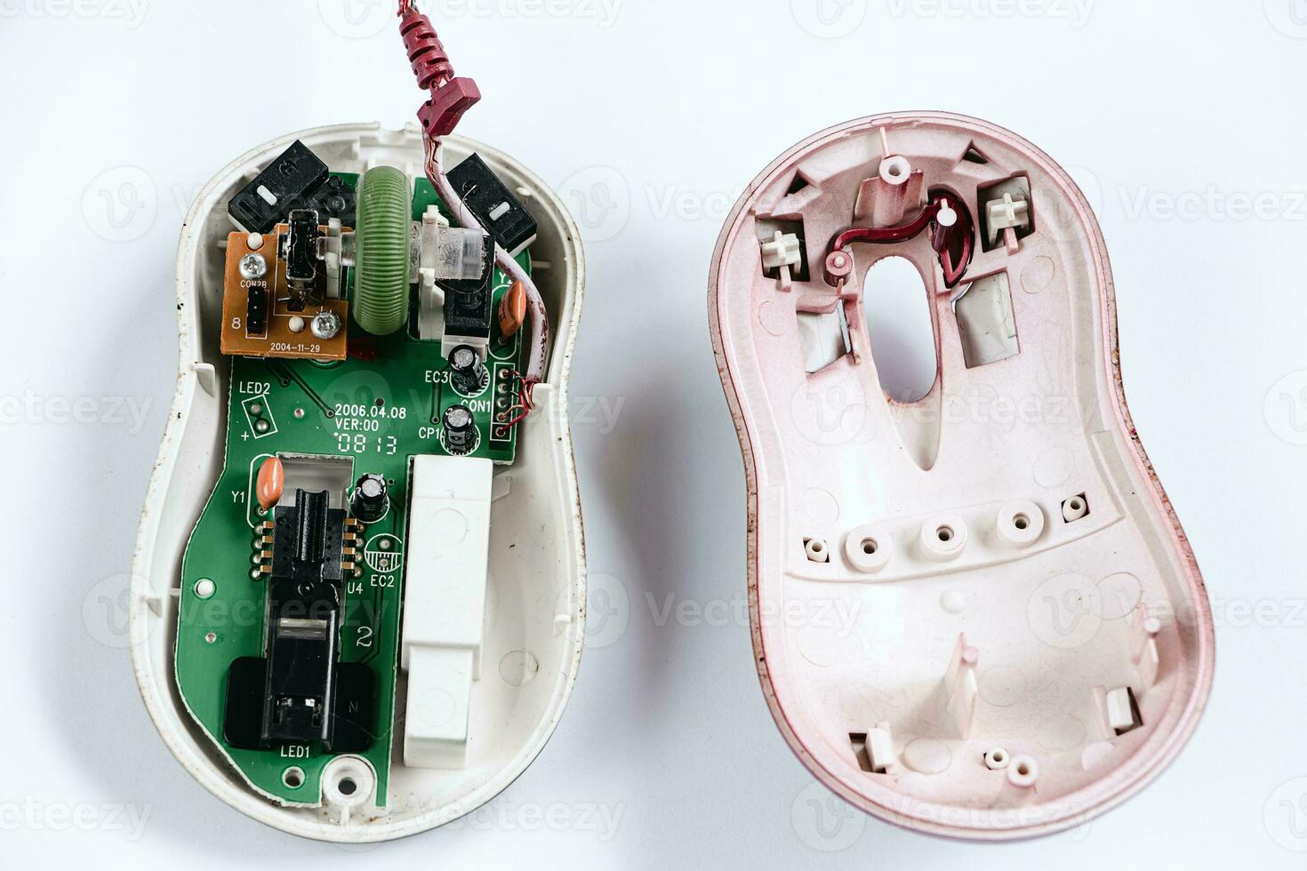 Disassembled computer mouse on white background. Gadget repair. photo