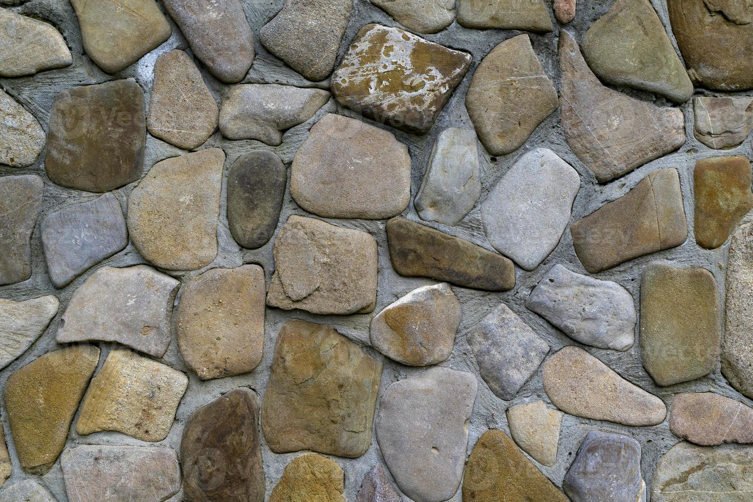 Texture of a stone wall. Old castle stone wall texture background. Stone wall as a background or texture. Part of a stone wall, for background or texture. photo