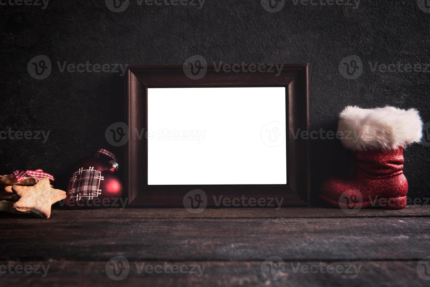 Blank frame on wooden background photo