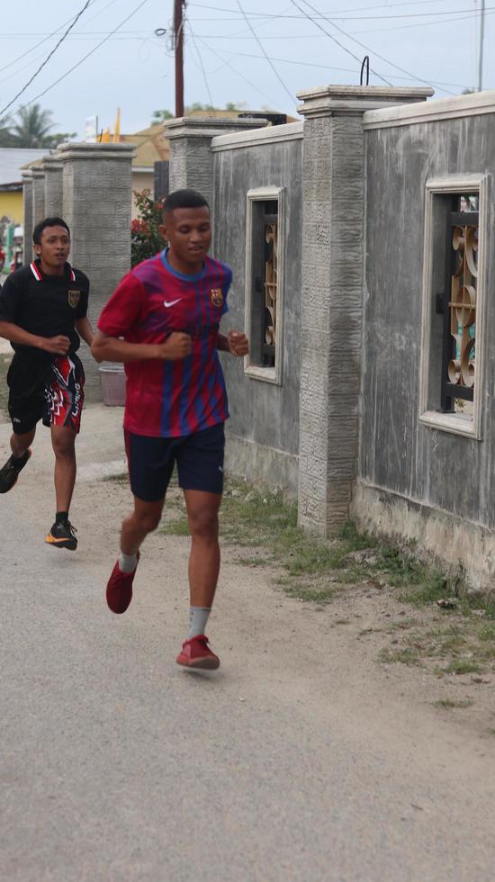 Gorontalo, March 2023 - Marathon running race, people feet on city road. Running people at a Marathon competition photo