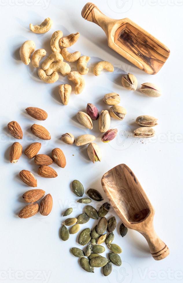 Splashed nuts on white background photo