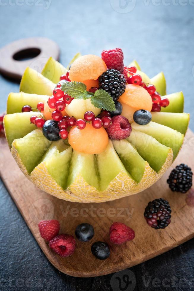 Served slice melons with berry fruits 23030541 Stock Photo at Vecteezy
