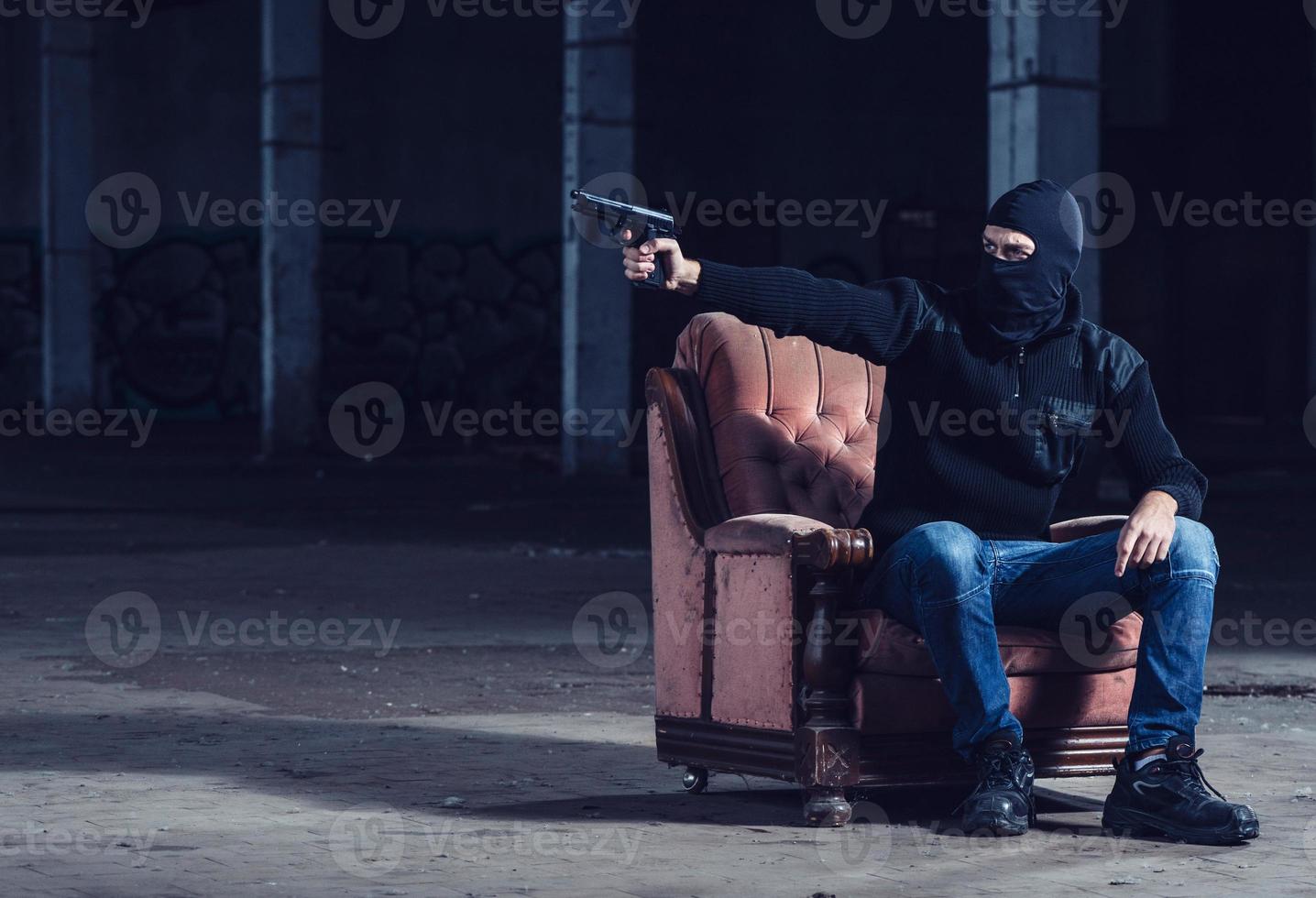 The terrorist pointing with gun photo