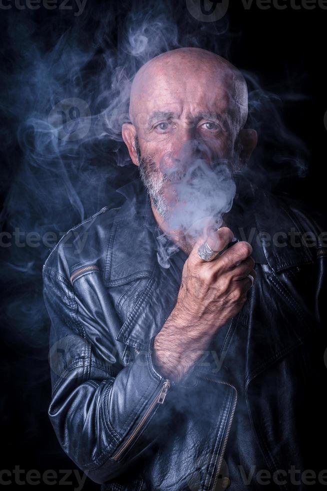 Smoking man portrait in low key photo