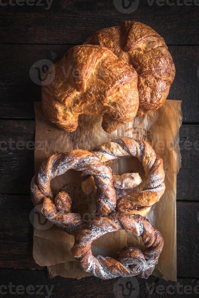 Sweet croissants and pretzels served photo