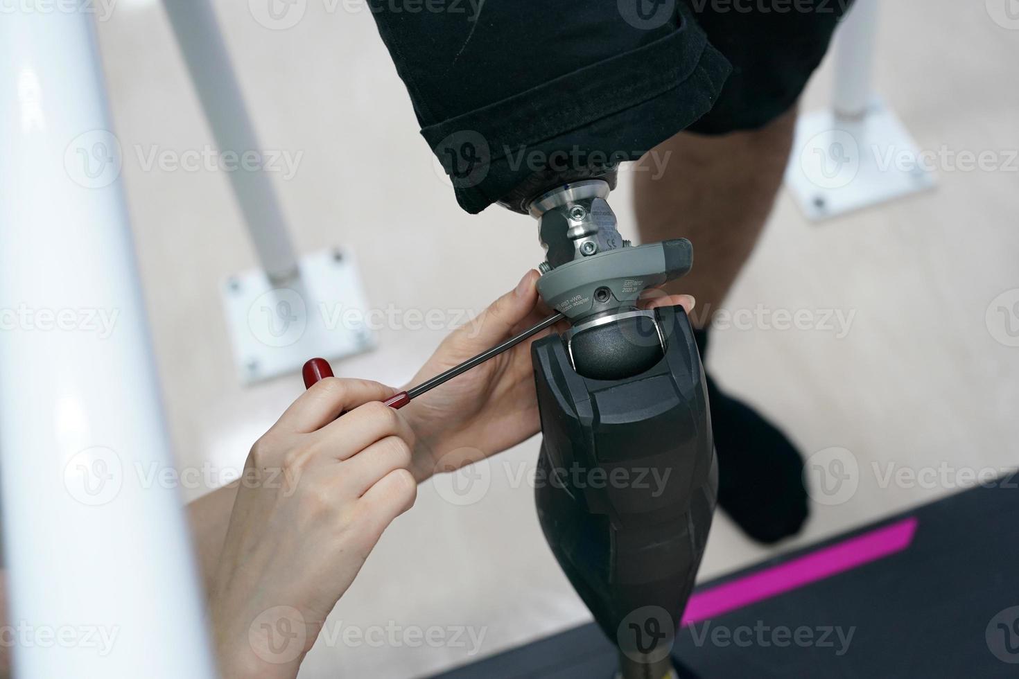 Orthopedic technician making prosthetic leg for disabilities people in workshop. photo