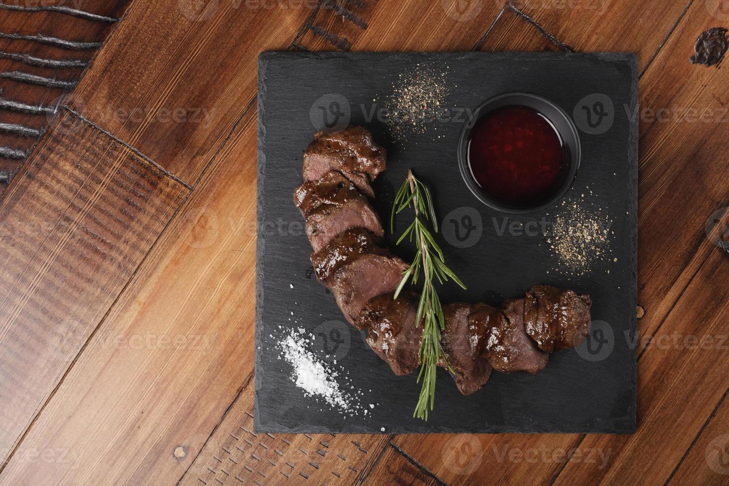 Grilled venison slices with rosemary photo