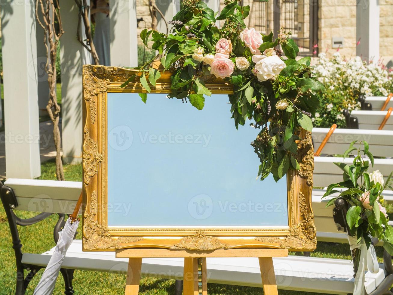 Wedding decorations. Plate with fresh flowers for of events inscription. Board for information and congratulations at ceremony and event photo