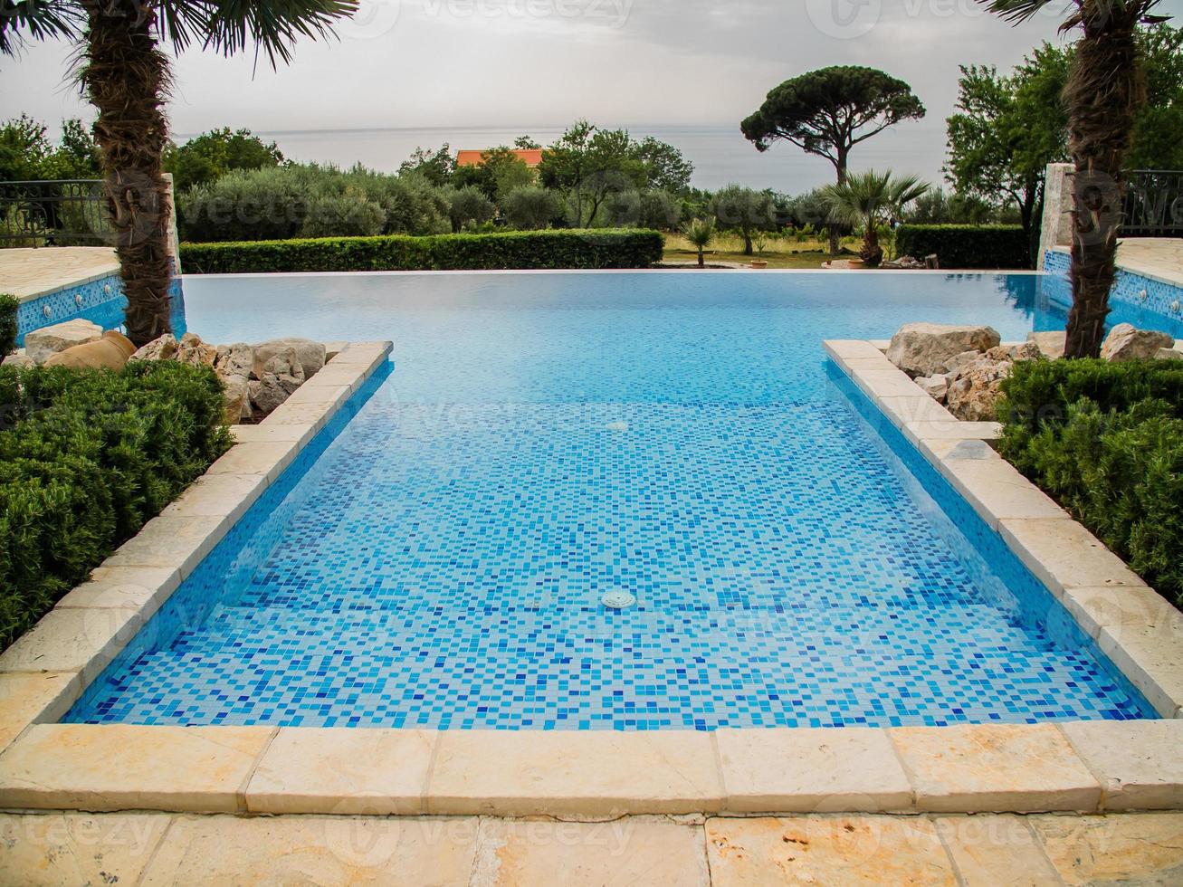 Home swimming pool in garden and villa terrace - summer holidays and luxury lifestyle concept photo