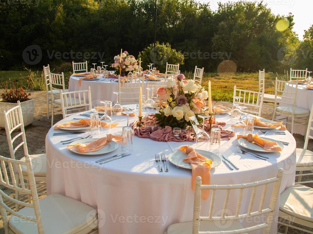 Table at luxury wedding reception event. Beautiful flowers on table and serving dishes and glasses and decoration photo