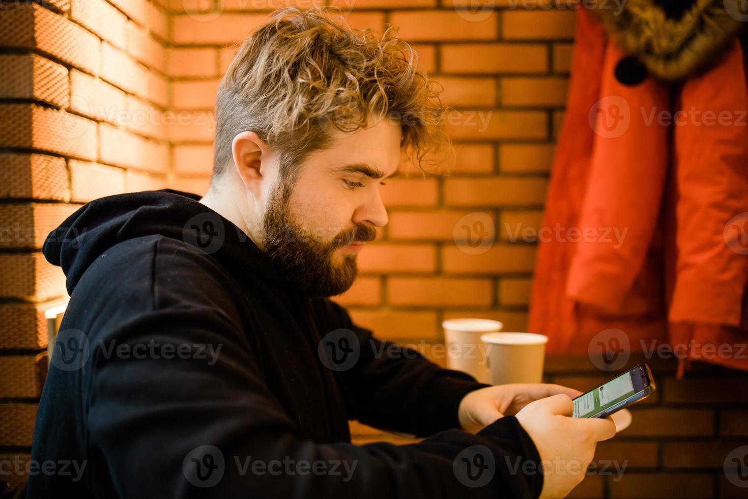 Social media and digital online concept - young man using smart phone with Social media. Living on vacation and playing social media concept photo