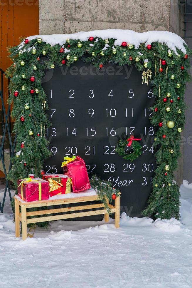 Simple desk advent calendar for December 2022 in city park with Christmas decorations photo