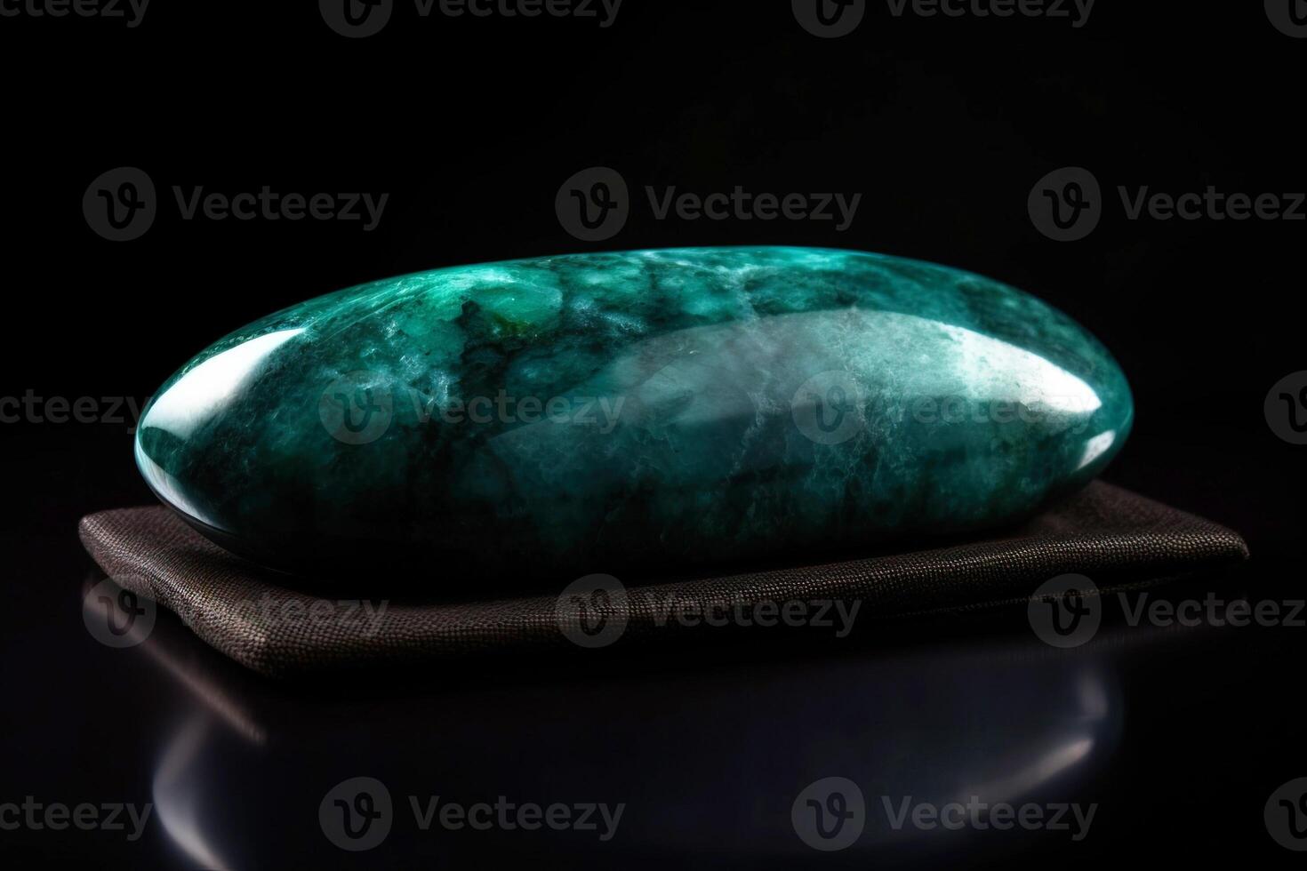 Jade is a rare precious natural geological stone eremite on a black background in low key. . photo