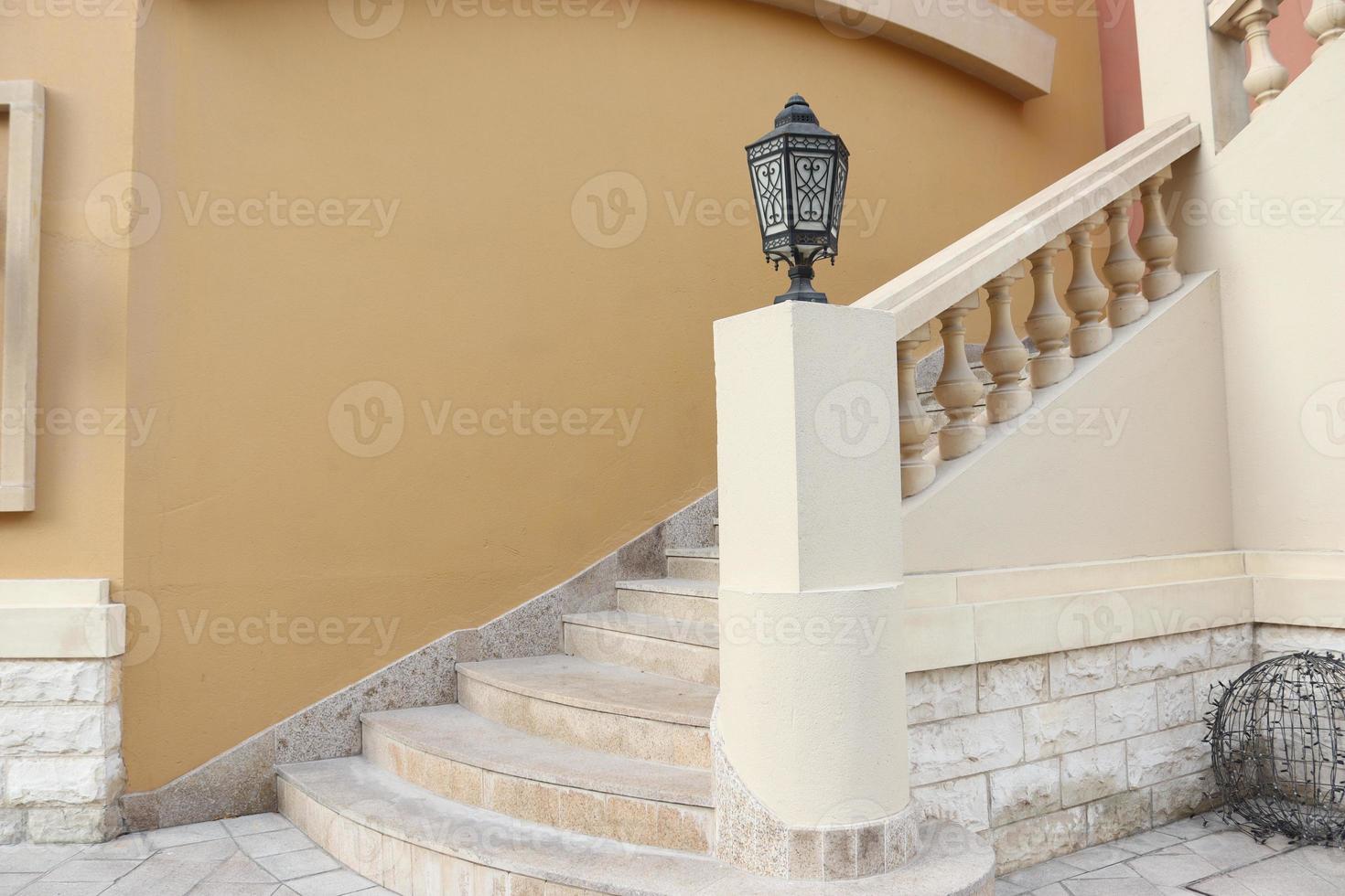 Empty stairs with yellow wall and black lamp indoor photo