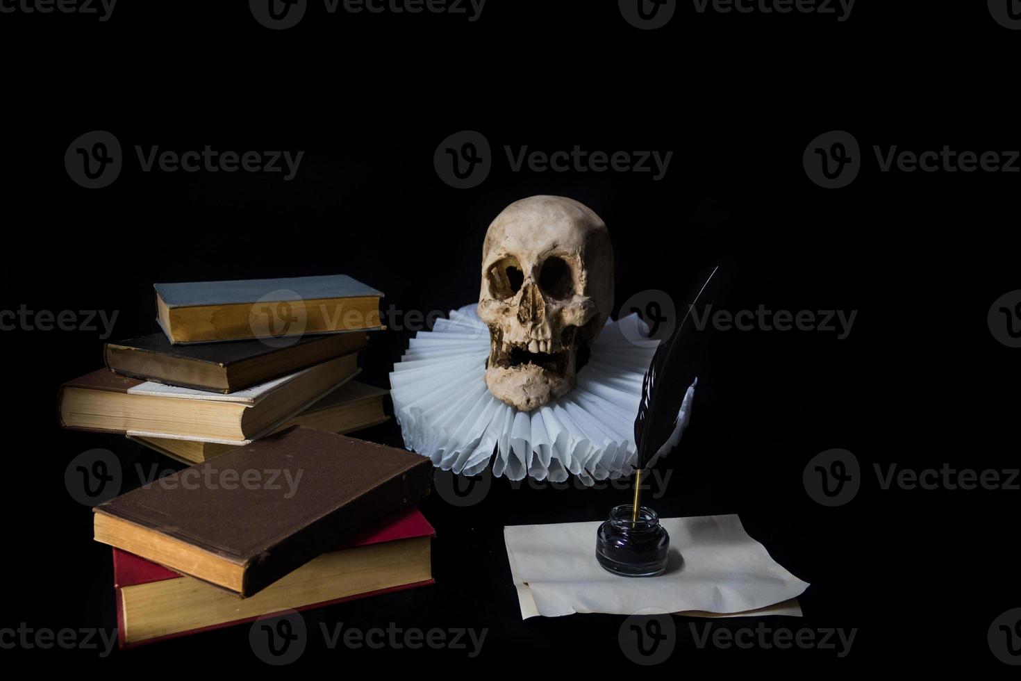 Books with a quill, inkwell, skull and ruff. world literature concept photo