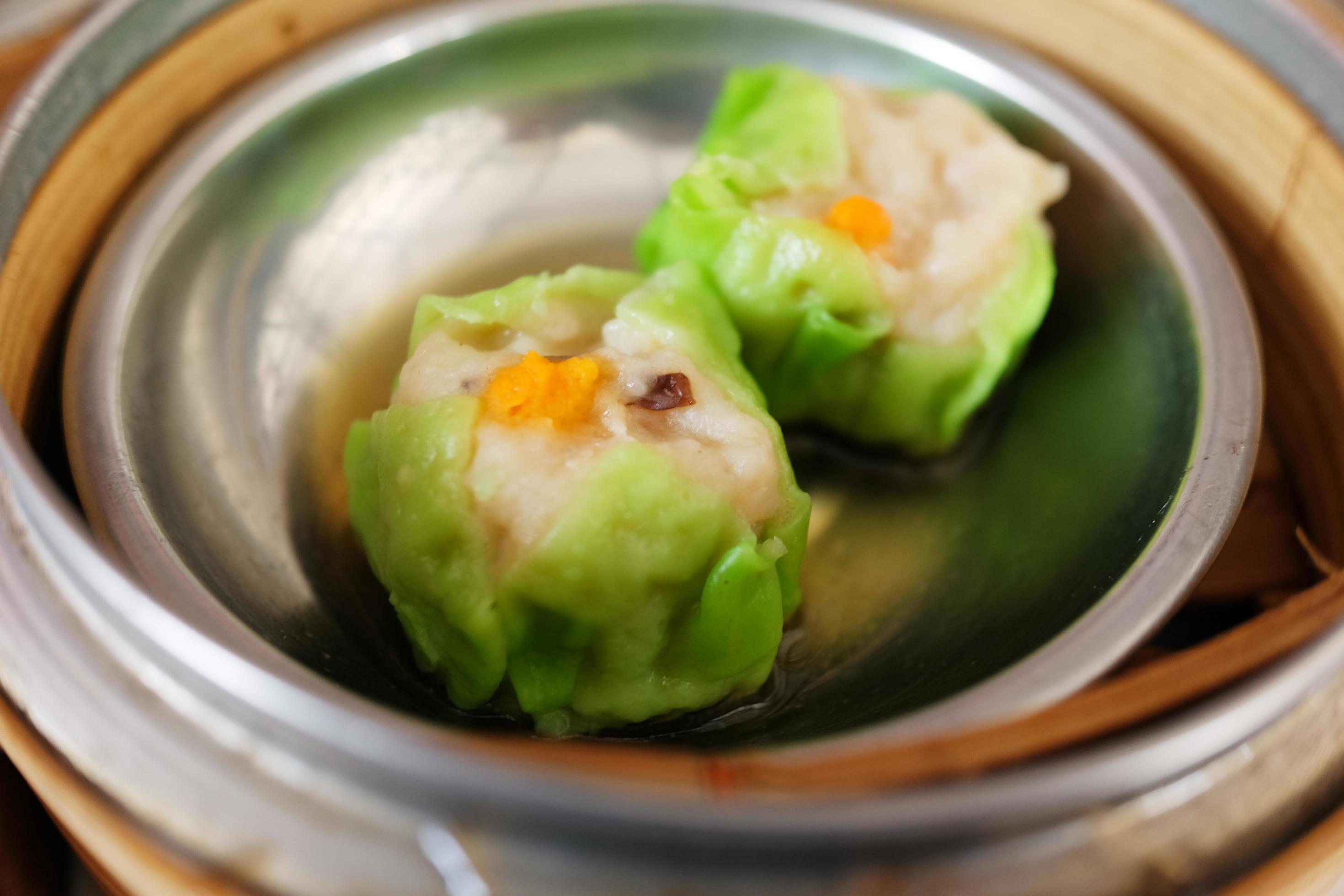 Traditional steamed chinese food Dim Sum and dumplings served preparation in bamboo basket