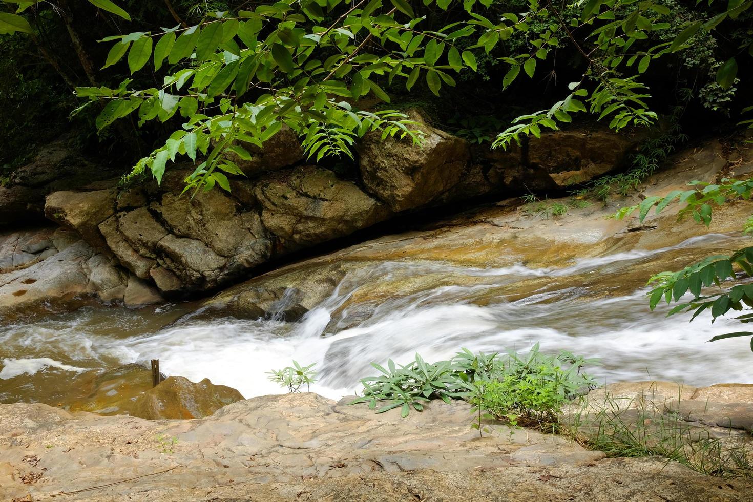 Waterfall and stream on the rock of tropical rainforest and evergreen forest in national park at Thailand photo
