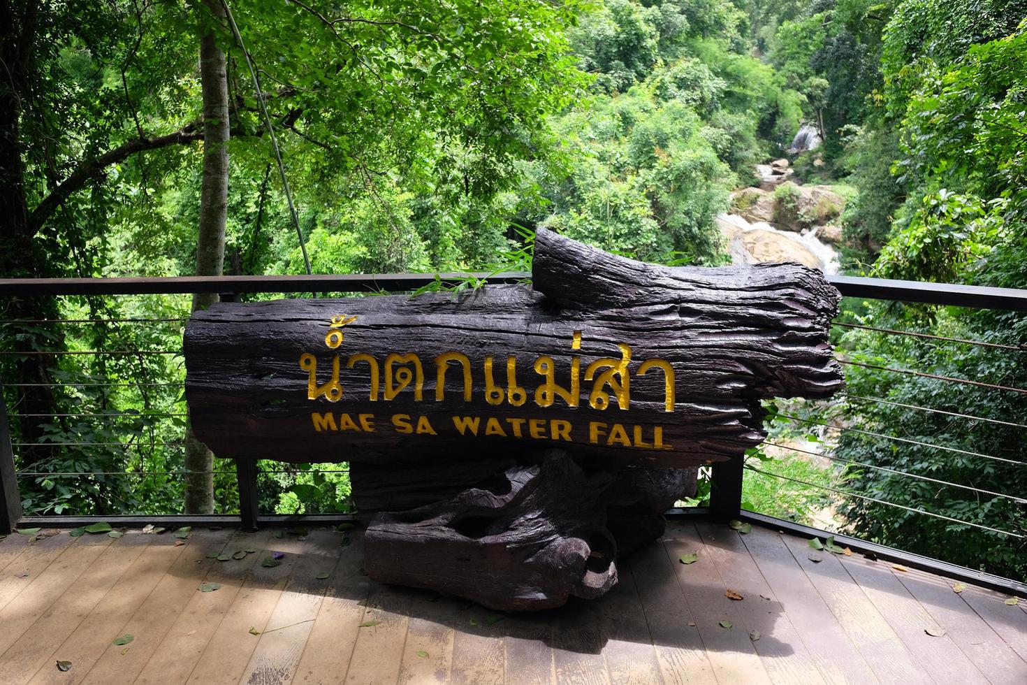 Wooden label showing the name of the Mea sa Water fall in the jungle of tropical rainforest photo