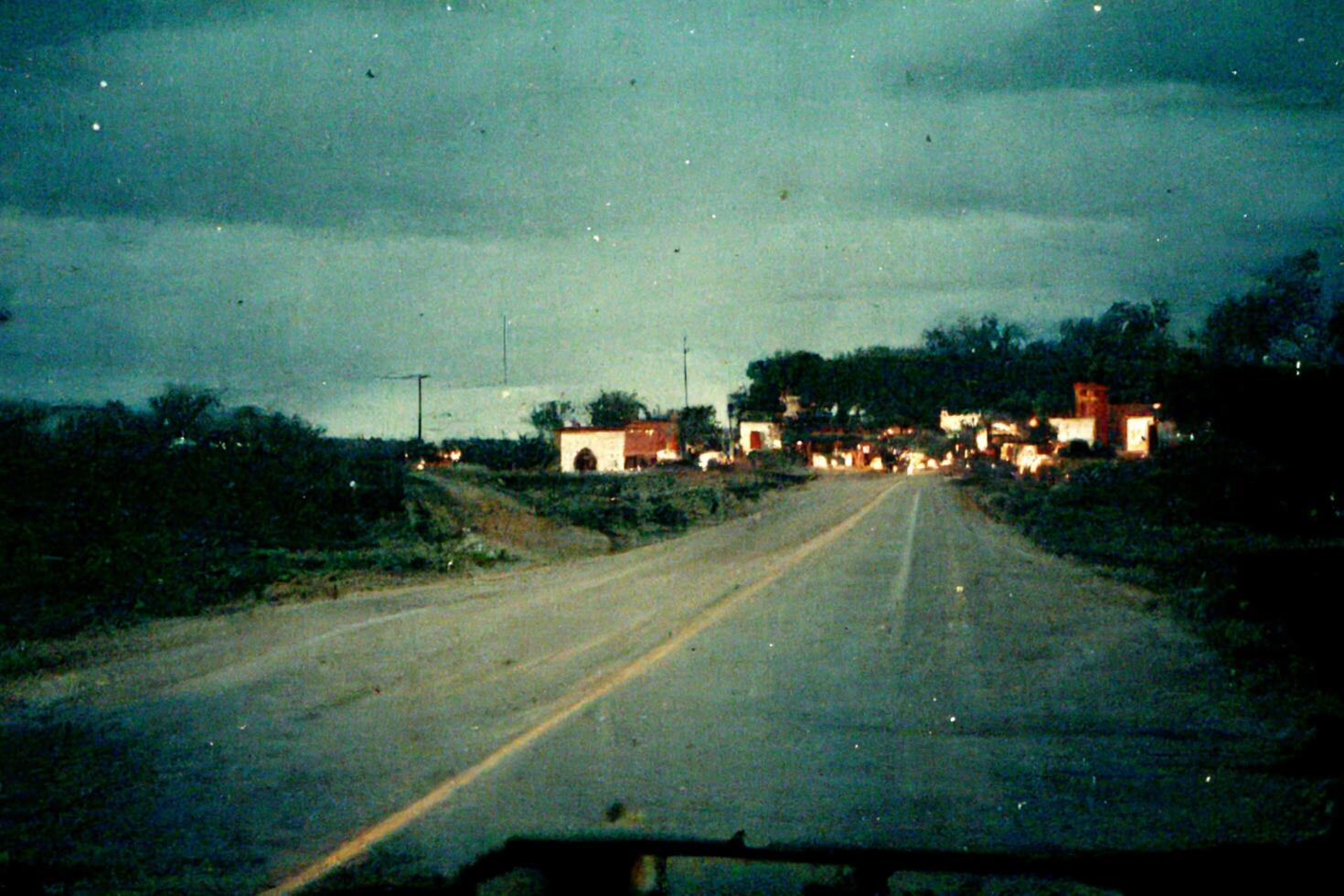 car driving down a rural road at night. . photo