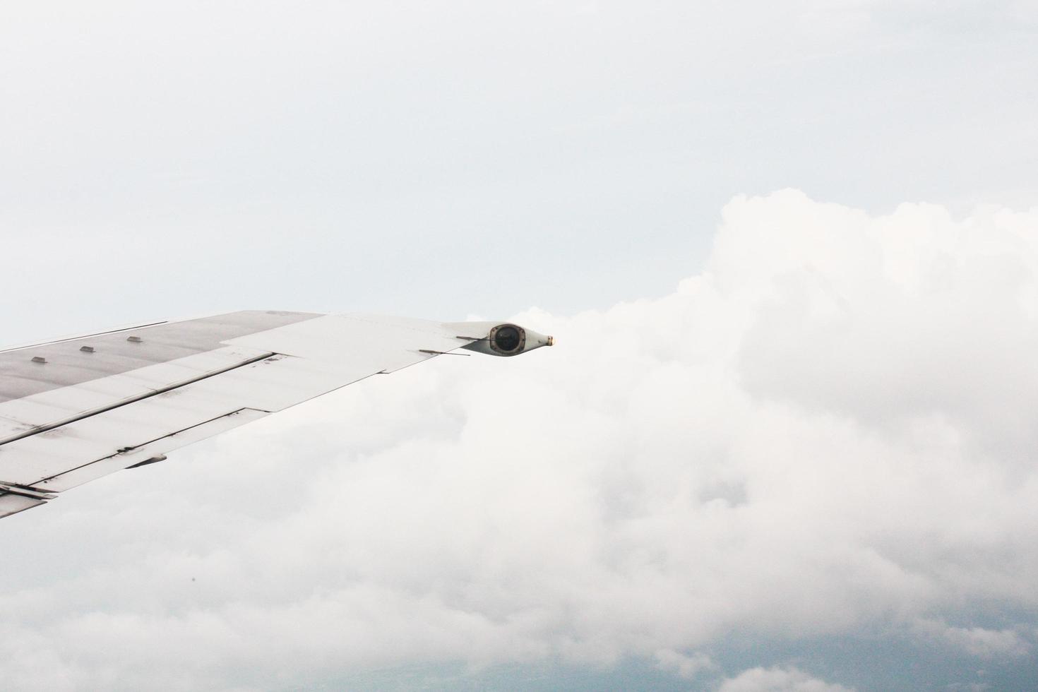 Aircraft Wing on the beautiful heaven and destination of journey on blue sky and cloud in sunlight photo