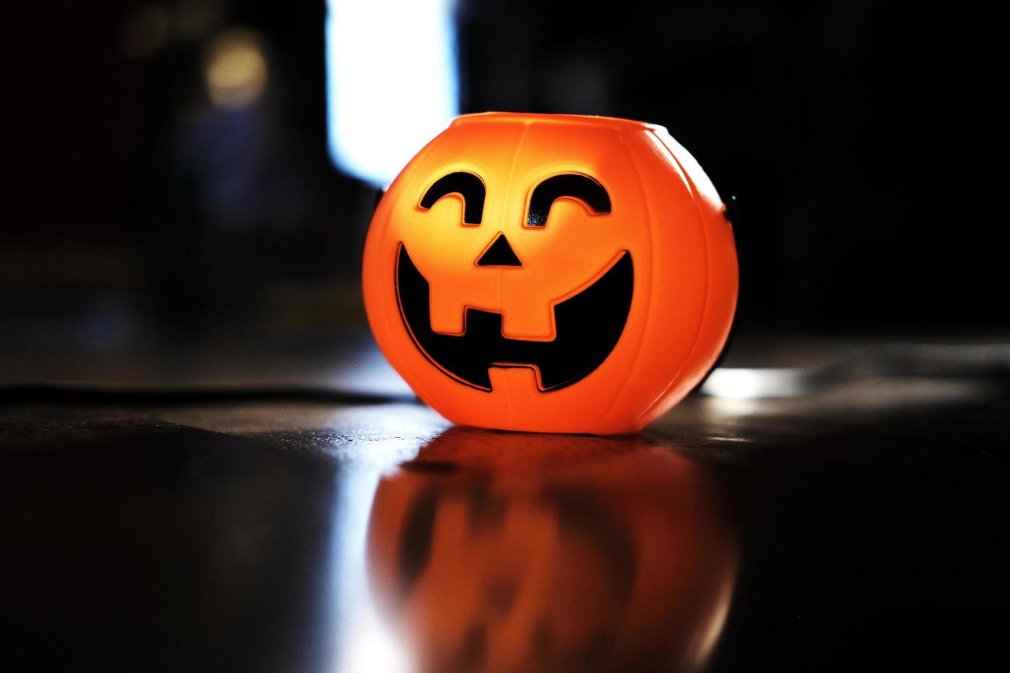 Halloween pumpkin head with golden light in dark night bakckground. Halloween holiday concept. photo