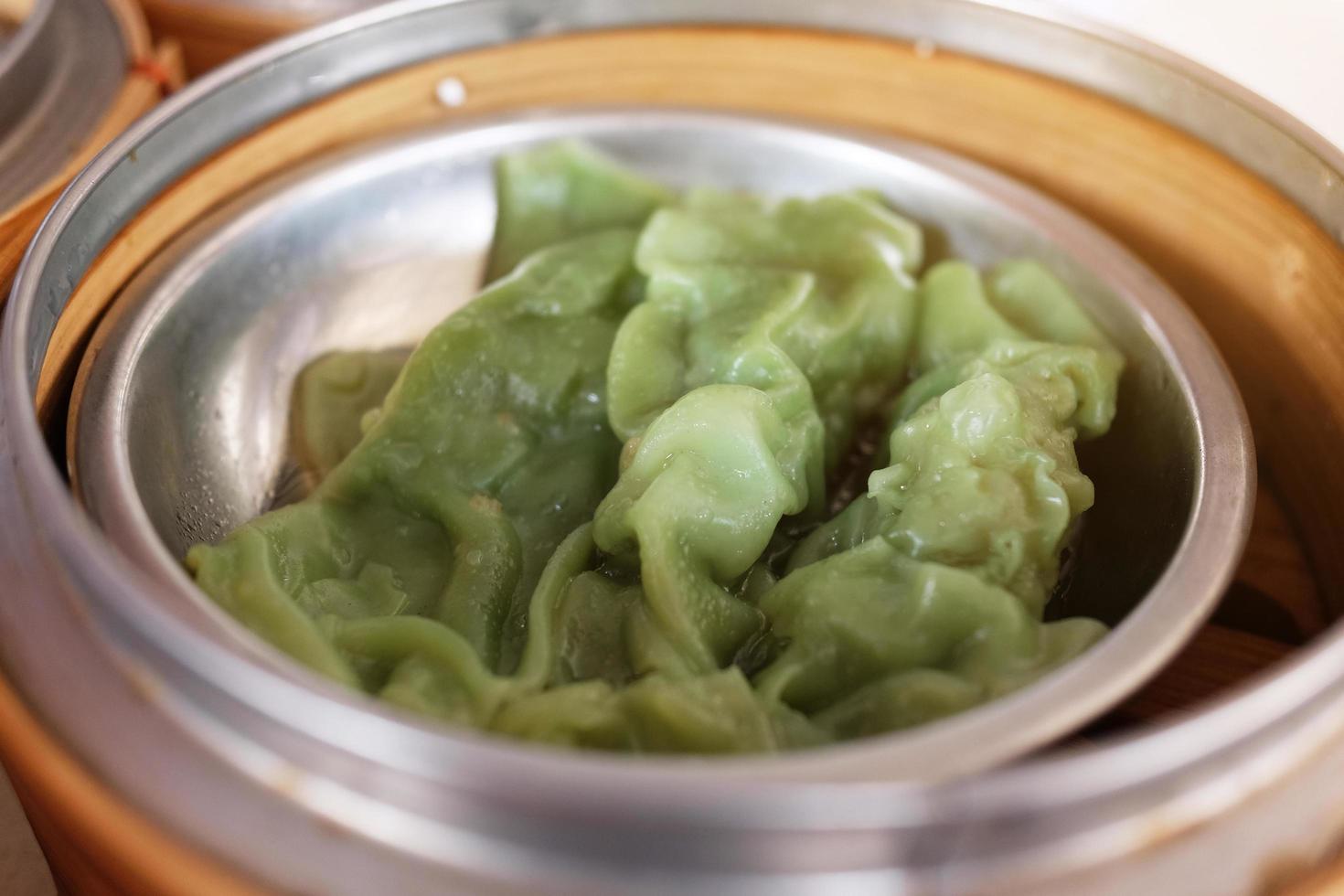 Traditional steamed chinese food Dim Sum and dumplings served preparation in bamboo basket