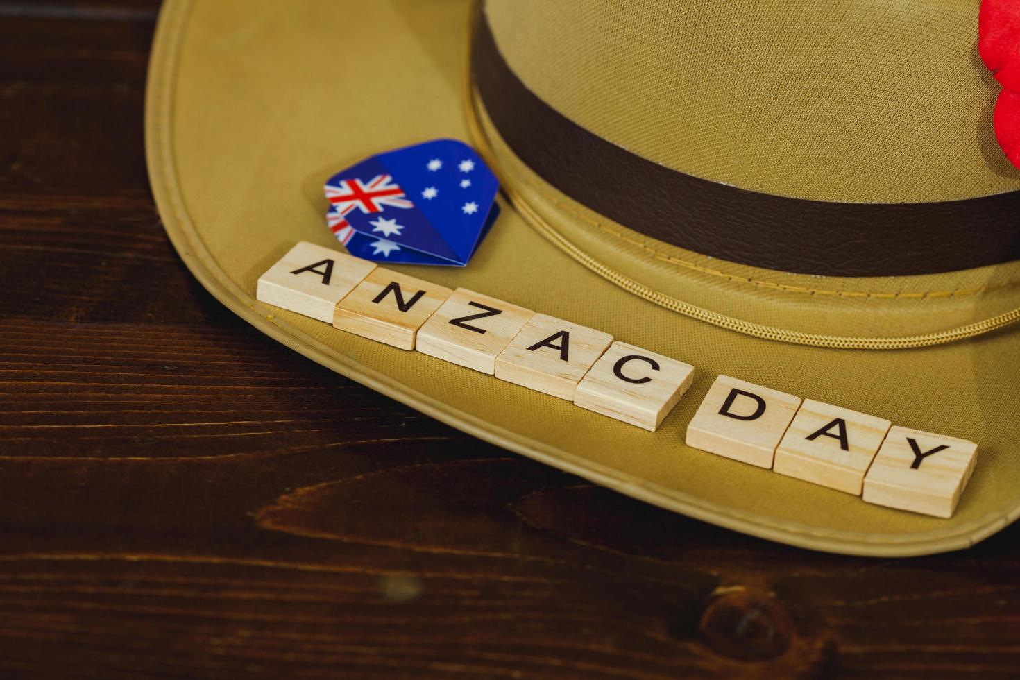 Anzac army slouch hat with Australian Flag on vintage wood background photo