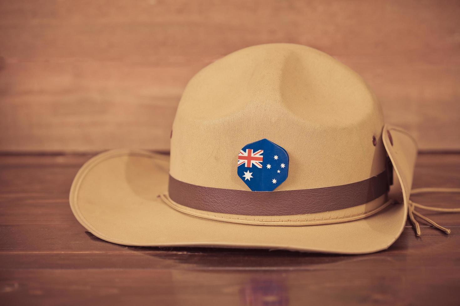 Anzac army slouch hat with Australian Flag on vintage wood background photo