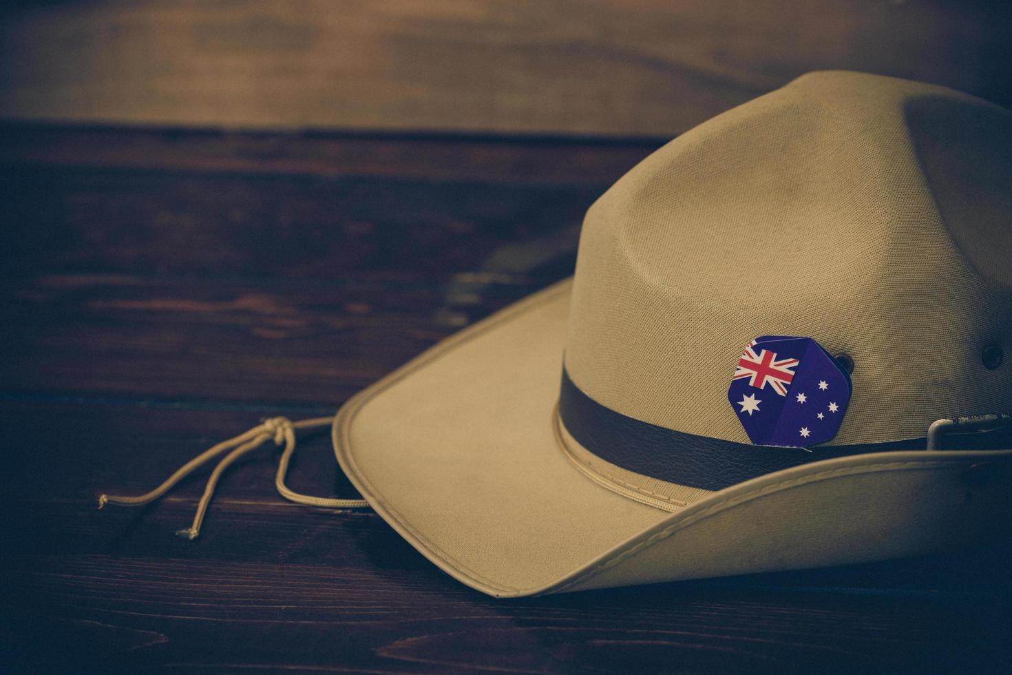 Anzac army slouch hat with Australian Flag on vintage wood background photo