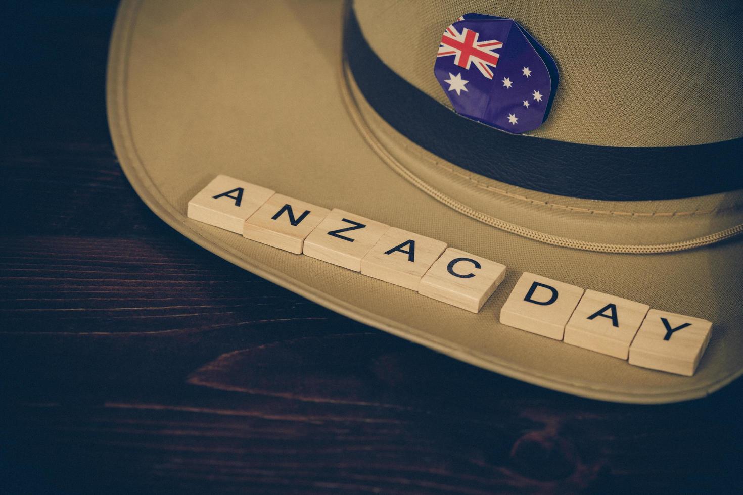 Anzac army slouch hat with Australian Flag on vintage wood background photo