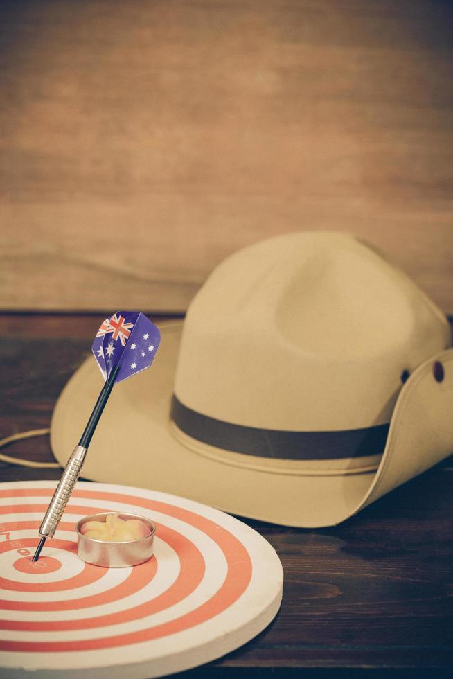 Anzac army slouch hat with Australian Flag on vintage wood background photo