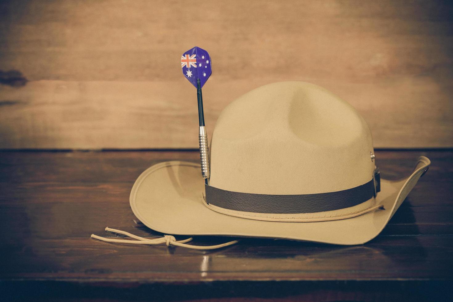 Anzac army slouch hat with Australian Flag on vintage wood background photo