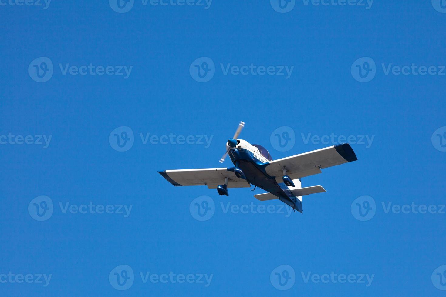 White and blue civil aircraft in mid air photo