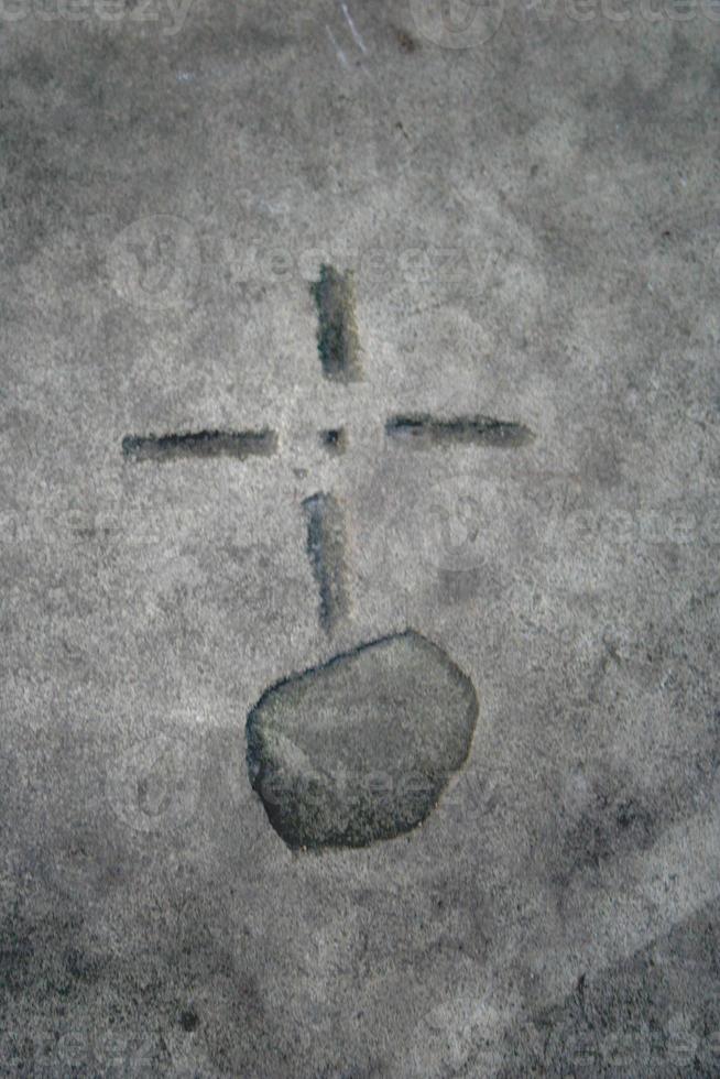 Orb and cross symbol carved on stone photo