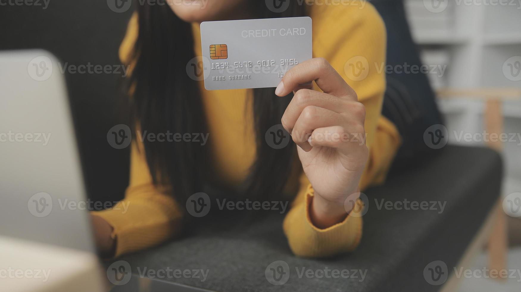 Close up of woman hand using credit card and laptop for payment and online shopping, Online shopping, payments digital banking, E-commerce concept. photo