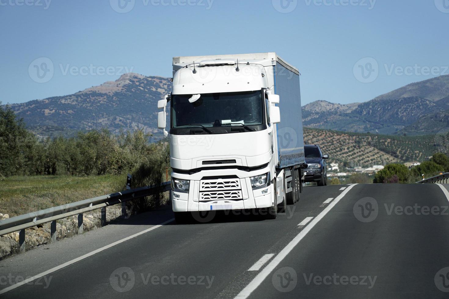 Truck on a Road - Front View, Mountains on Second Plan photo