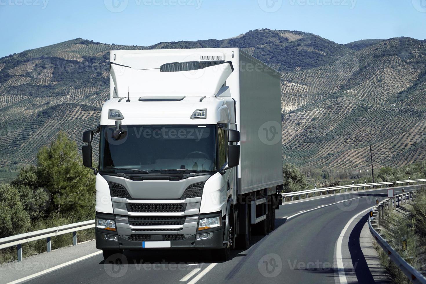 Truck on a Road - Front View, Mountains on Second Plan photo