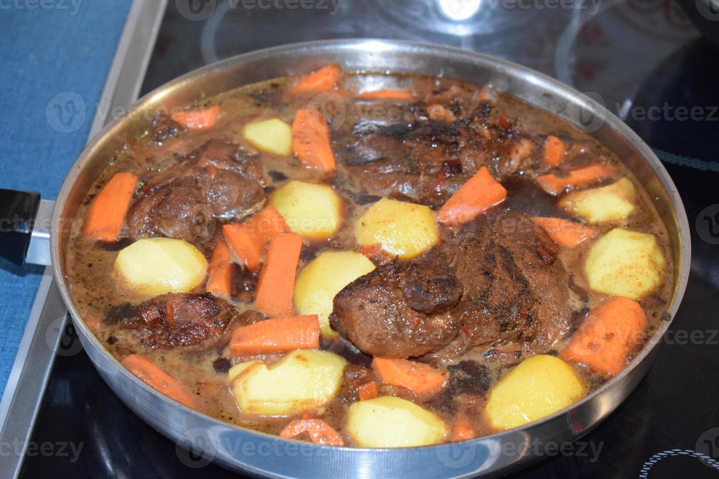 Fried Bacon with Carrots and Potatoes in a Dark Sauce photo
