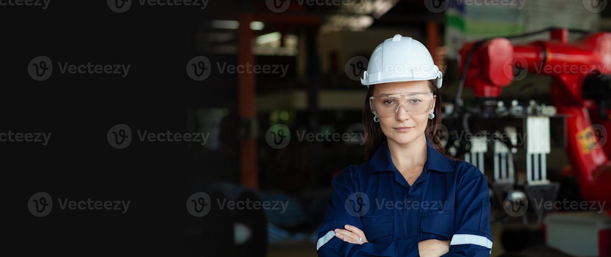 Female mechanical engineer working in machinery in industry. Workers wearing safety glasses. Working. Industrial concept. photo