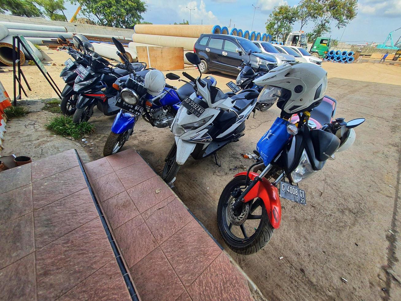 Jakarta, Indonesia in July 2022. A makeshift motorbike parking lot of an office. photo