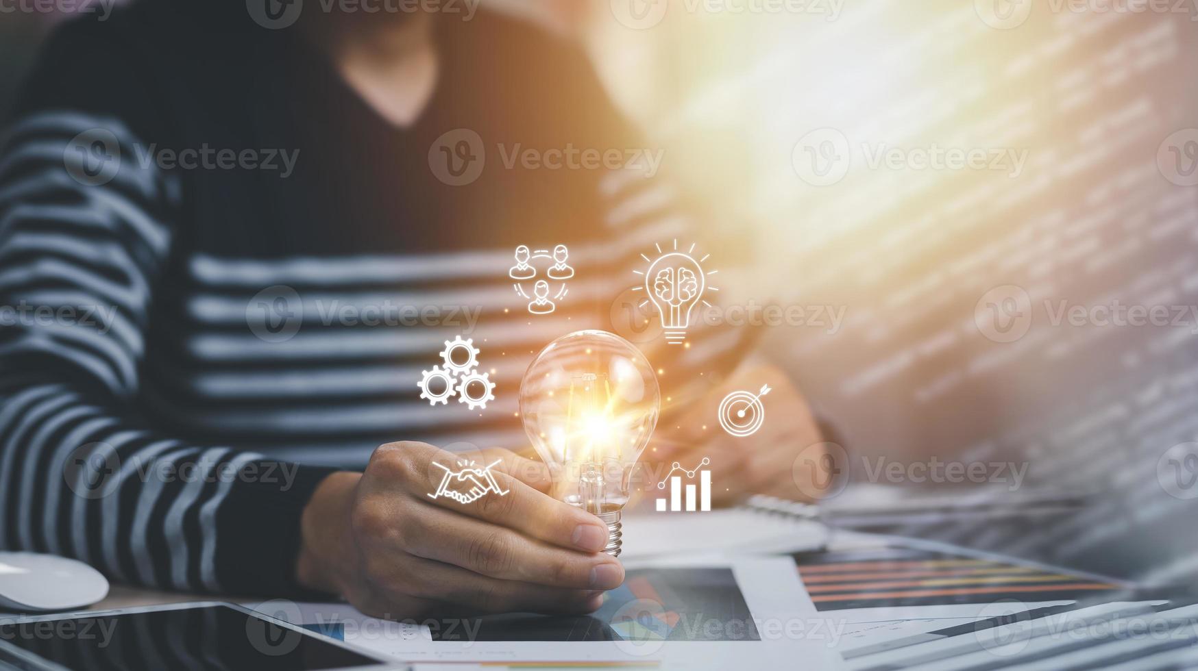 thinking and creative concept, Close up light bulb and working on the desk, Creativity and innovation are keys to success.Concept of new idea and innovation with Brain and light bulbs, working at home photo