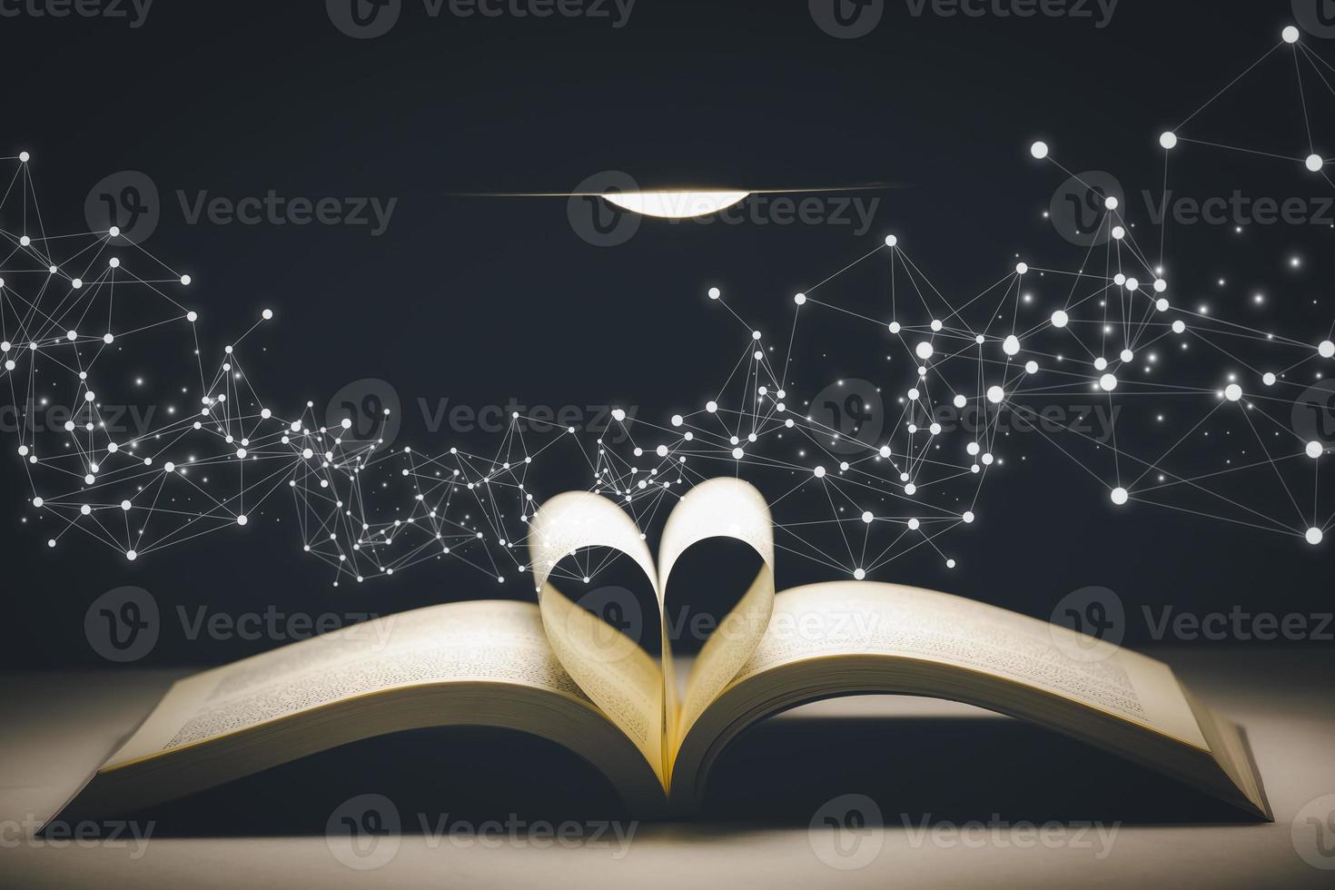 Heart-shaped folding book in the golden bokeh backdrop, Concept ideas for reading and love, soft-focus bokeh background,Concept The idea of reading books, knowledge, and searching for new ideas. photo