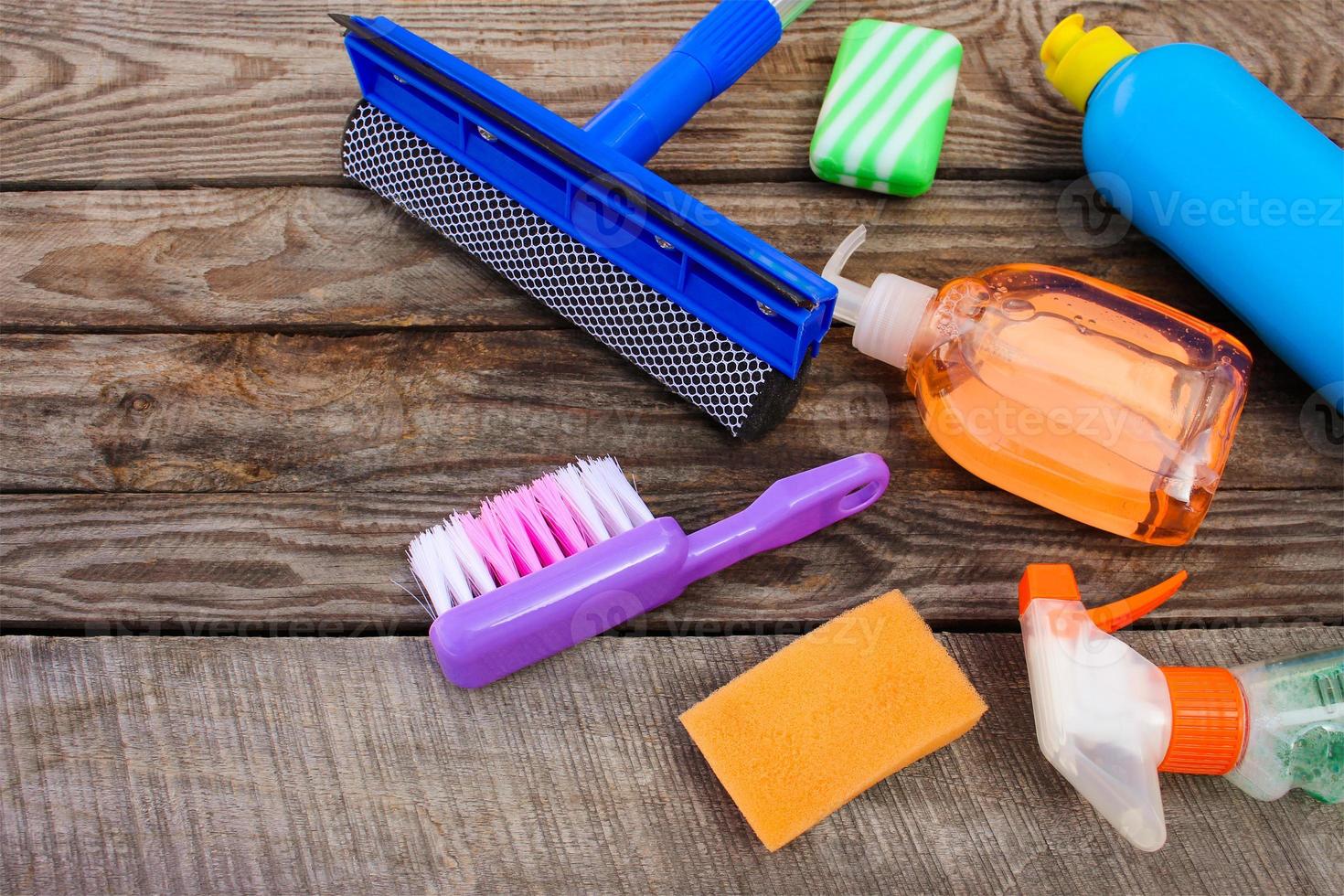 Cleaning products on wooden background. Toned image photo