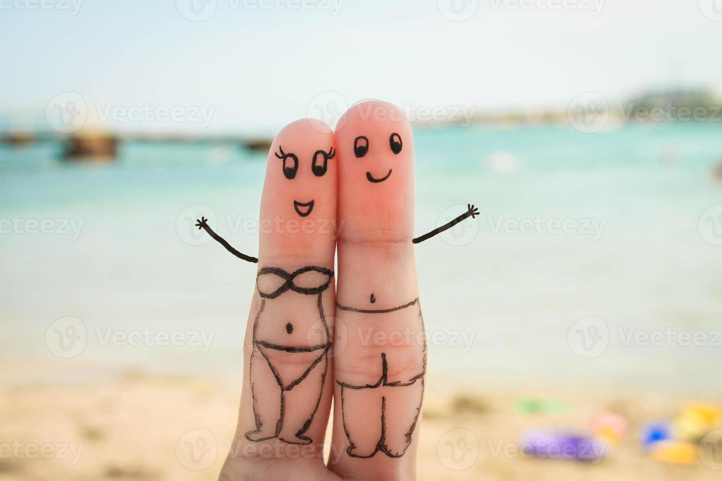 Happy couple have a rest on the beach in bathing suits photo