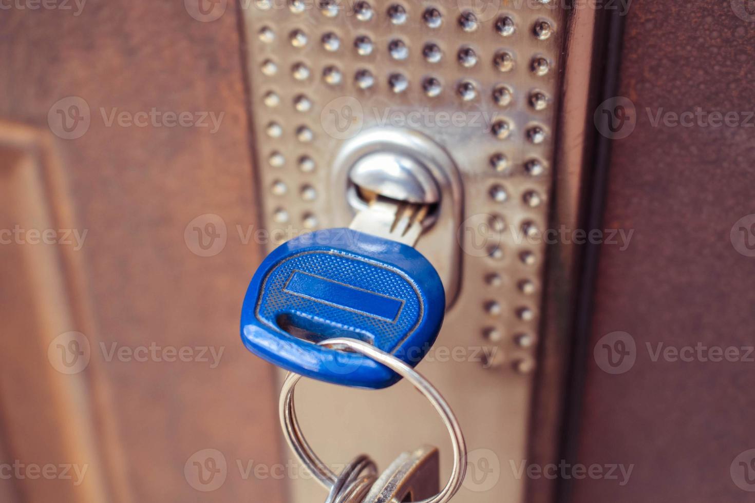 The key in the lock of the iron door. Toned image. photo