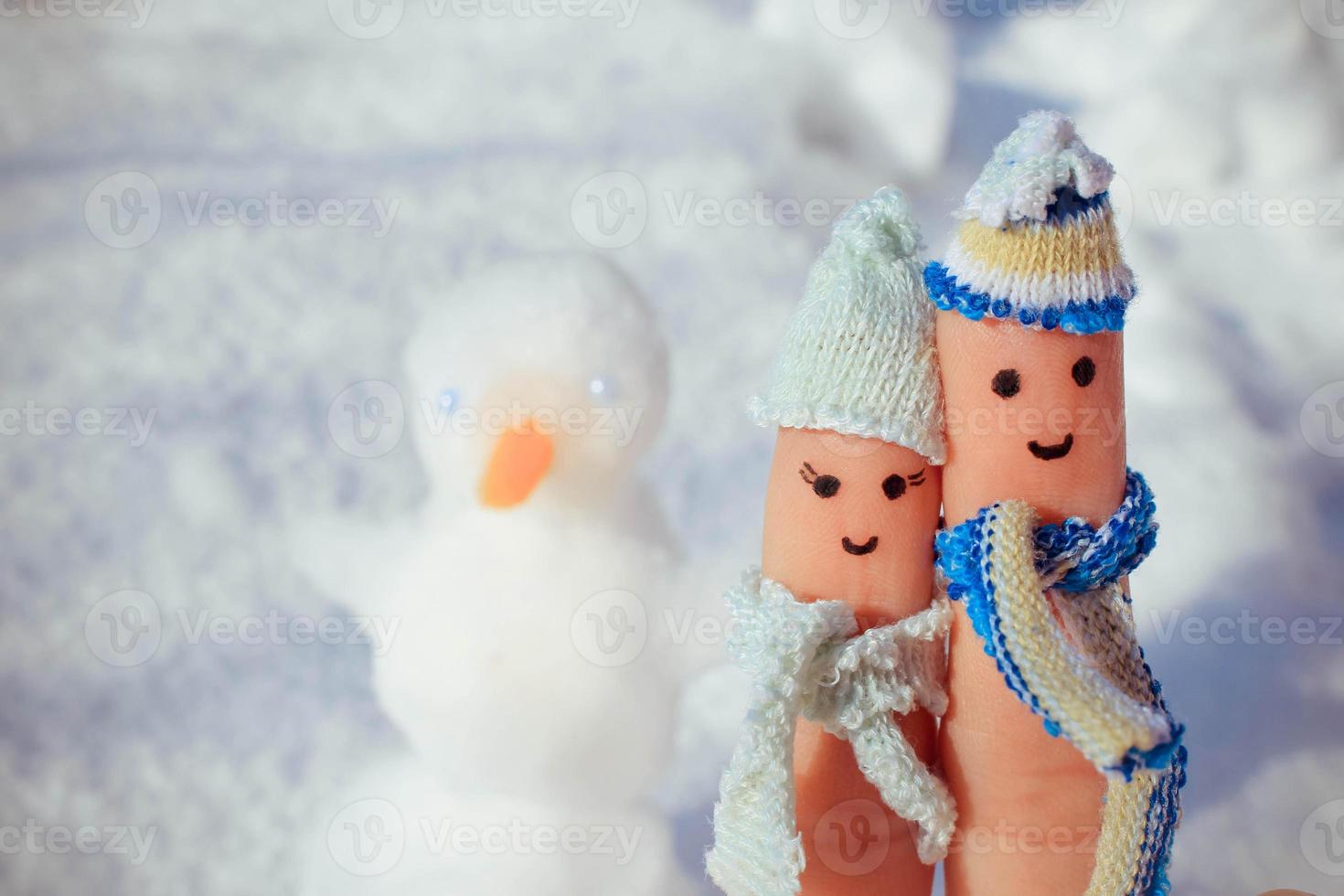 Finger art of a Happy couple on the background of snow. A man and a woman hug. photo